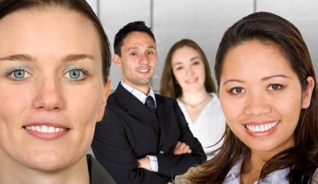 business female partners with their team - focus is on the caucasian woman