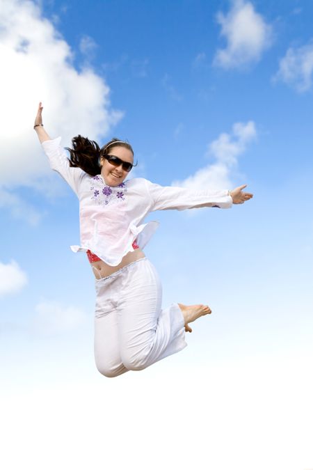 girl jumping on the air over a blue sky