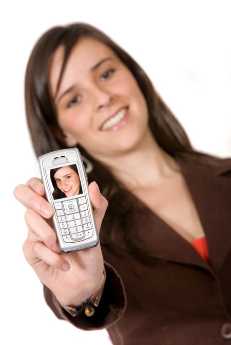 beautiful girl showing her photo on her mobile phone over a white background