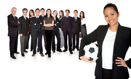 asian business woman holding a football with her whole team behind her
