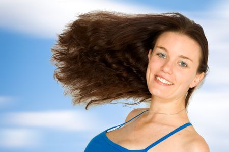 beautiful and fresh female portrait over a blue sky
