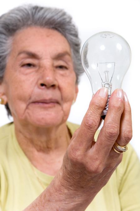 creative old lady holding a lightbulb over a white background