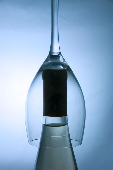 Crystal glass upside down on bottle of wine