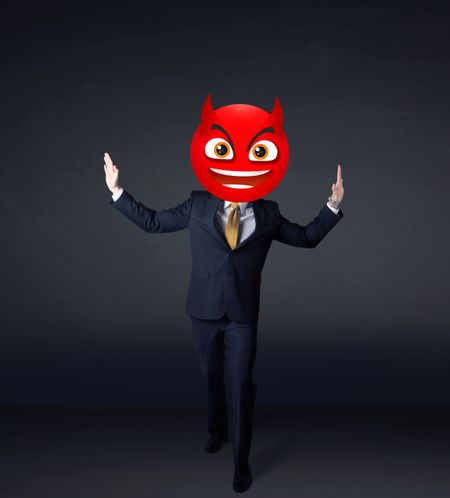 Funny businessman wears devil face