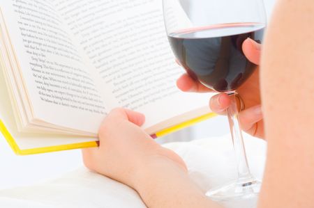 Reading book with red wine