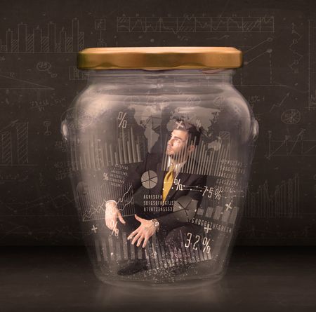 Businessman traped in jar with graph chart symbols concept on background