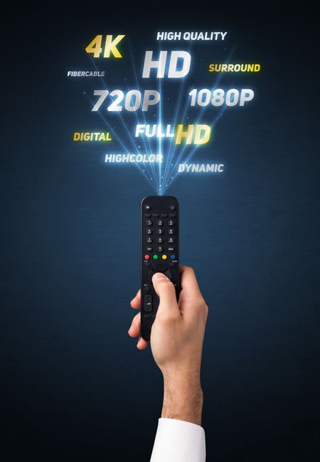 Hand holding a remote control, multimedia properties coming out of it 