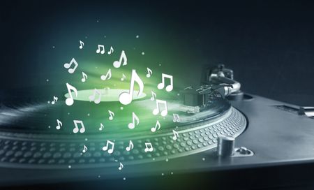Turntable playing music with audio notes glowing concept on background