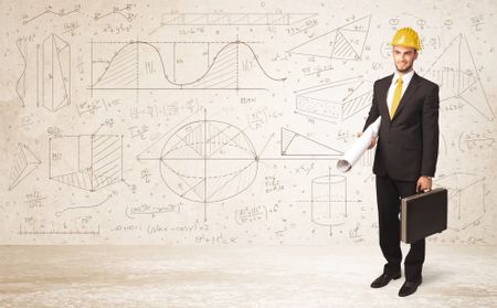 Handsome engineer calculating with hand drawn background concept