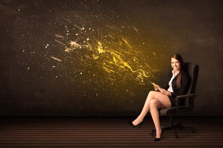 Businesswoman with tablet and energy explosion on background concept