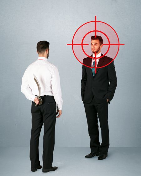 ruthless-businessman-handshake-hiding-weapon-head-264683798 Ruthless businessman handshake with a hiding weapon and a head target point