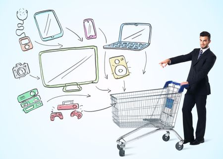 Businessman pushing a shopping cart drawn media devices coming out of it