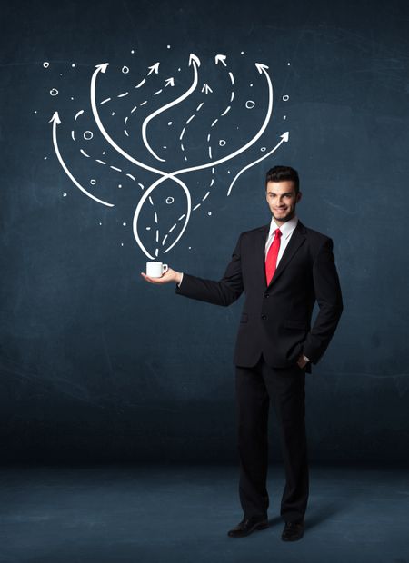 Businessman standing and holding a white cup with drawn lines and arrows coming out of the cup