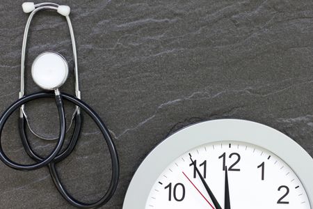 Concept showing doctors stethoscope and a clock face simulating an appointment