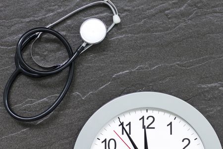 Concept showing doctors stethoscope and a clock face simulating an appointment