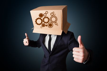 Businessman standing and gesturing with a cardboard box on his head with spur wheels