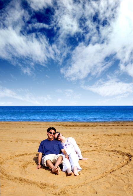 couple in love - heart shape on the beach with a beautiful blue sky