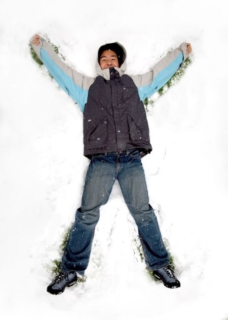 man having fun in the snow at winter time