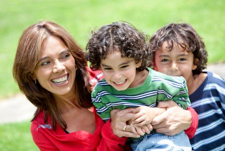 Beautiful portrait of a mother with her two sons outdoors