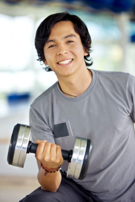 man portrait at the gym with free weights