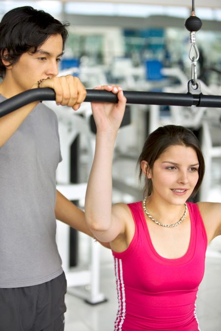 woman exercise at the gym with a personal trainer