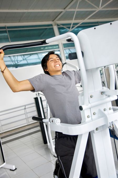 Young man at the gym doing chin ups