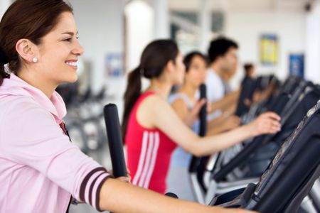 People working out at the gym on cardio machines
