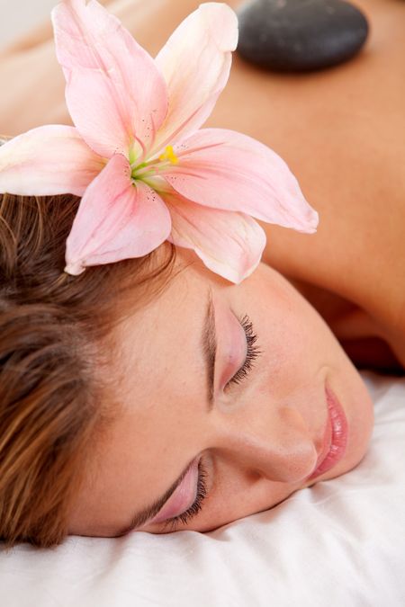 Woman relaxing at a spa getting a lastone therapy