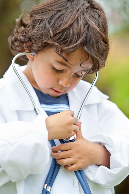 Kid listening to his own heart with a stethoscope