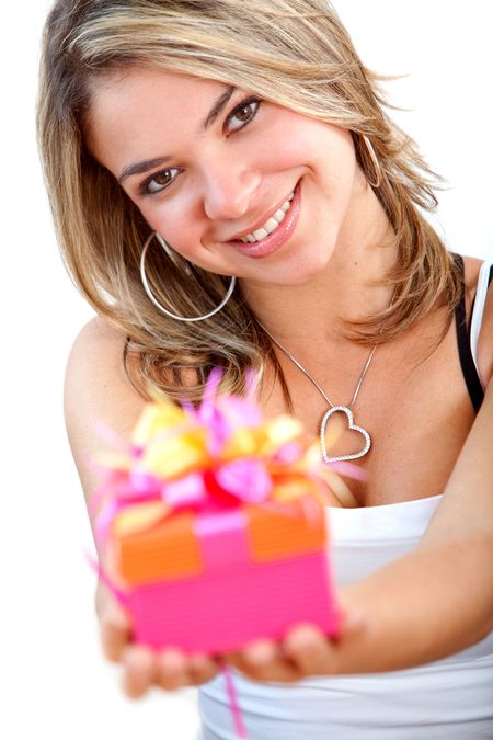 Beautiful girl holding a gift isolated over white