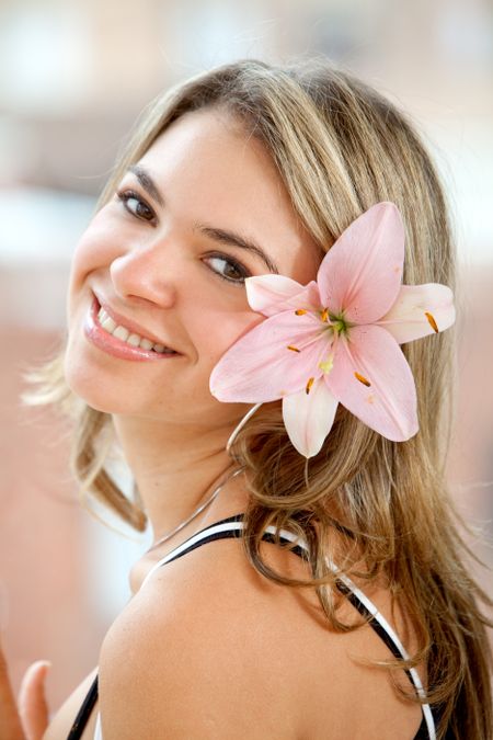 Beautiful woman with a flower on her head