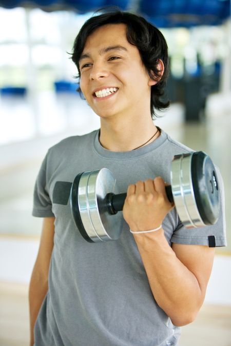 Man at the gym exercising with free weights