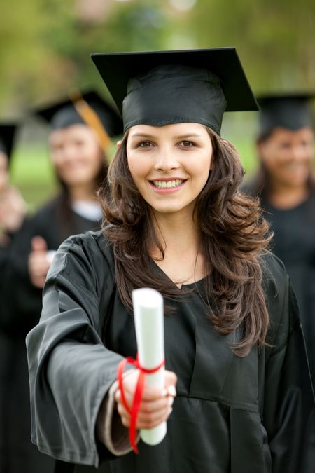 Female graduation portrait smiling and showing her diploma