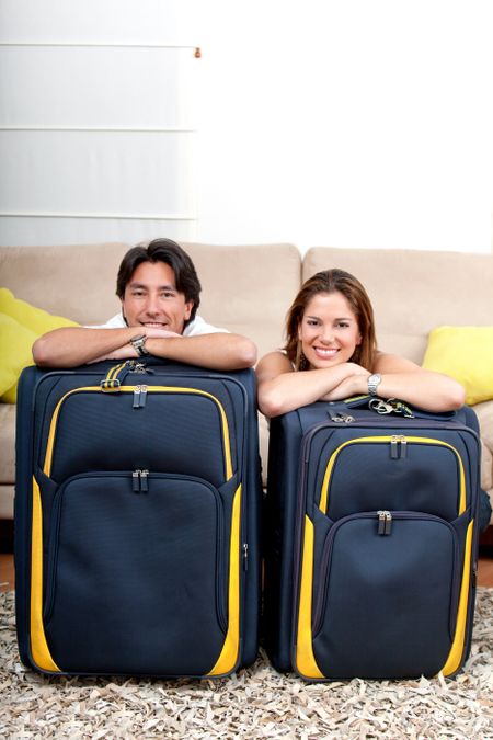 Happy couple with bags ready to travel