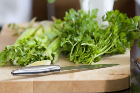 celery and parsely on cutting board