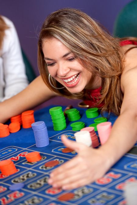 Woman in a casino gambling and winning