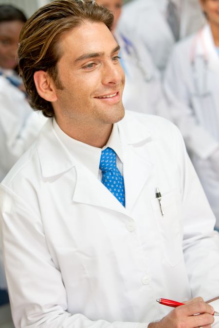 Young male doctor smiling in a hospital