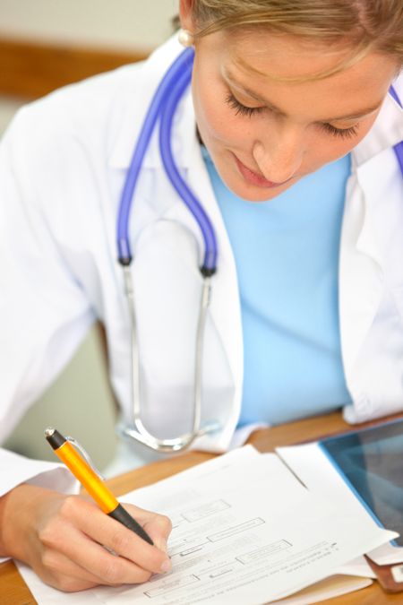 Doctor filling medical history at a hospital room