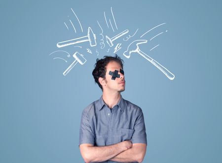 Young man with taped eye and white drawn beating hammer marks around his head