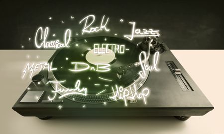 Turntable with vinyl and music genres writen concept on background