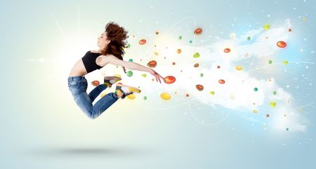 Beautiful woman jumping with colorful gems and crystals on the background concept