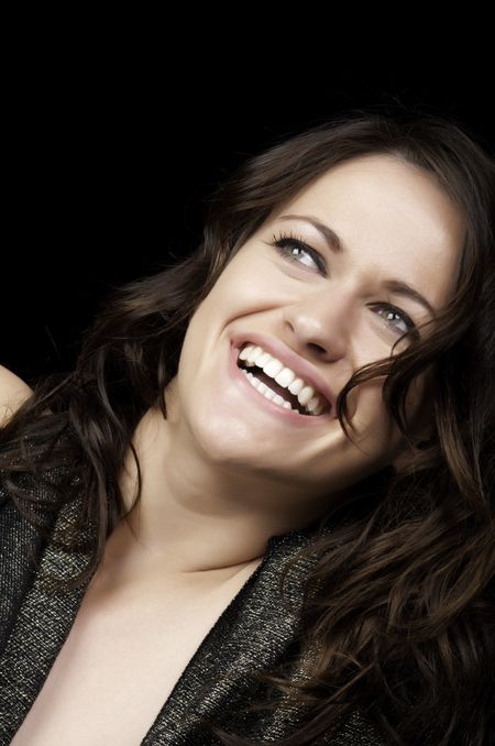 Laughing young brunette looking upward