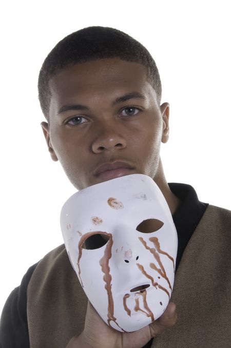 Handsome black man holding blood-stained white mask below his face