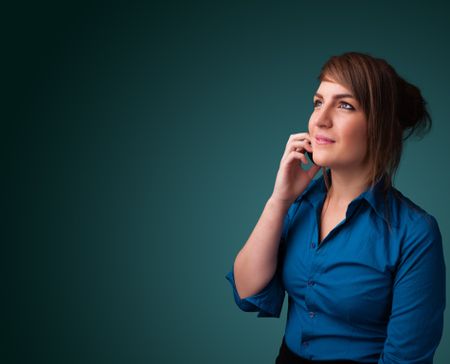 Young woman standing and making phone call with copy space