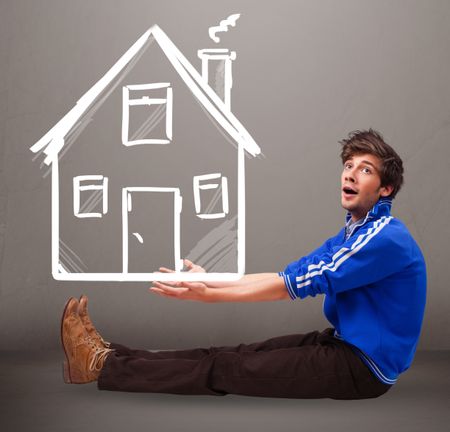 Attractive young boy holding a huge drawn house