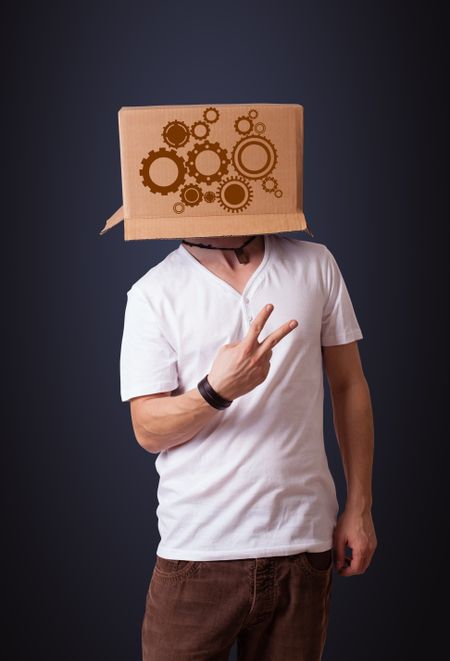 Young man standing and gesturing with a cardboard box on his head with spur wheels