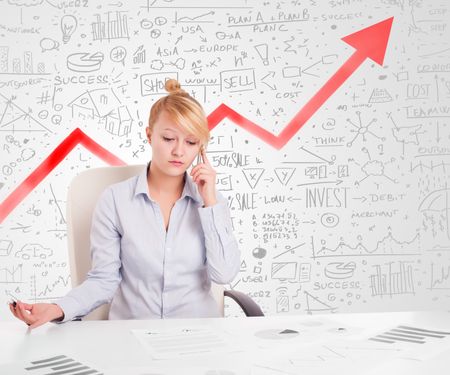 Business woman sitting at table with market hand drawn diagrams 