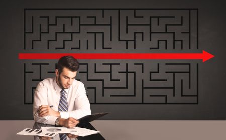 Successful businessman with a solved puzzle in background