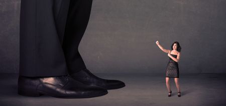 Huge legs with small businesswoman standing in front concept on background