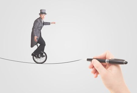 Businessman riding monocycle on a rope drawn by hand concept